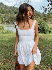 White mini dress with structured bodice and square neckline, front view