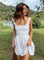 White mini dress with structured bodice and square neckline, front view