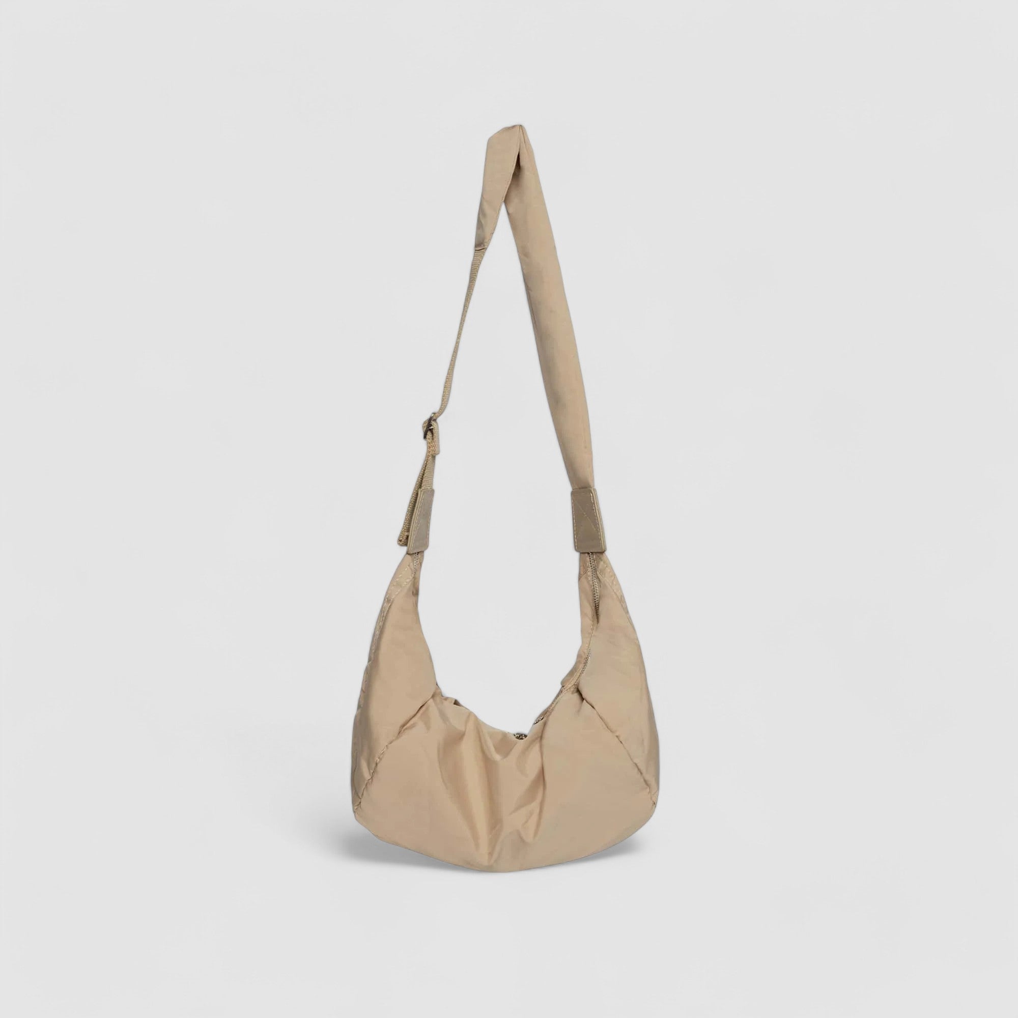 Schoudertas beige puffer stijl met lange schouderriem detail
