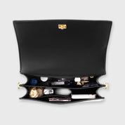 Black crocodile-print shoulder bag interior contents view