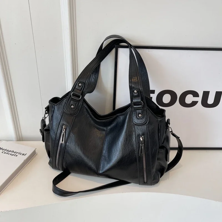 Amber Compacte schoudertas met verstelbare band en stijlvol silhouet