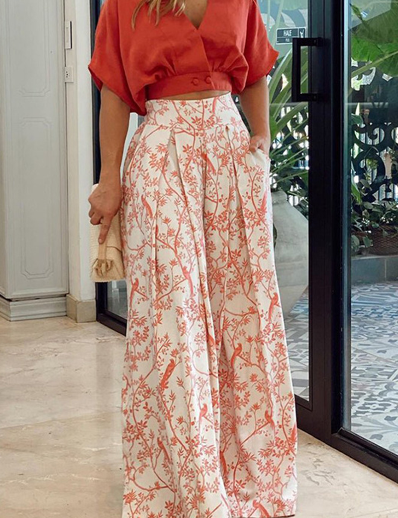 Red crop top and white pants with bird print, side view