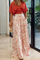 Red crop top and white pants with bird print, side view