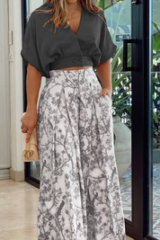 Black crop top and white pants with bird print, side view