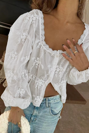White blouse with floral embroidery three-quarter view
