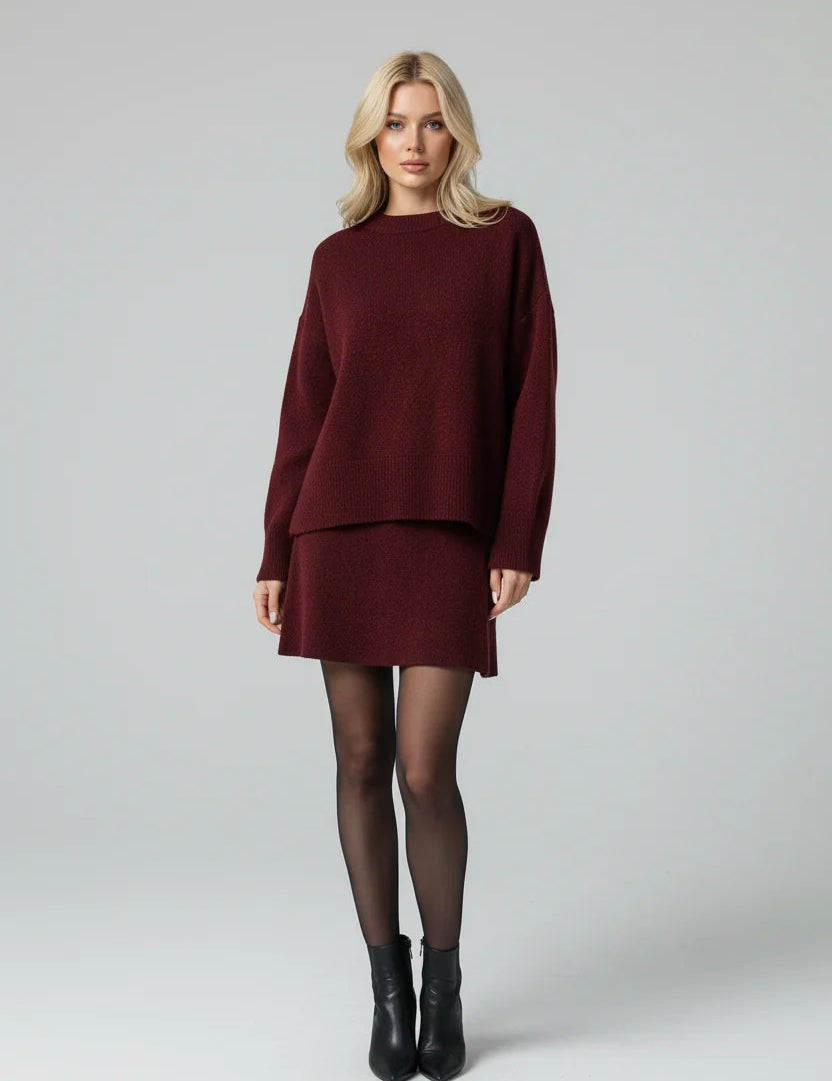 Burgundy knit set with flared skirt and black boots front view