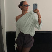 Blouse with draped fabric and floral detail, mirror selfie