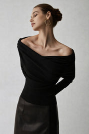 Black off-shoulder sweater with draped neckline, side view