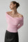 Pink off-shoulder sweater with draped neckline, side view