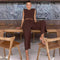 Brown two-piece set with crop top and wide-leg pants seated pose