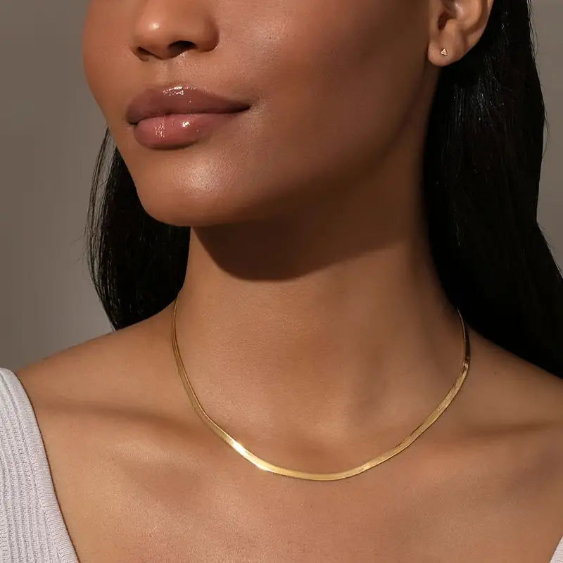 Gold herringbone necklace close-up on model