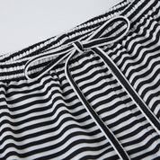 Wide-leg trousers black and white striped waistband close-up