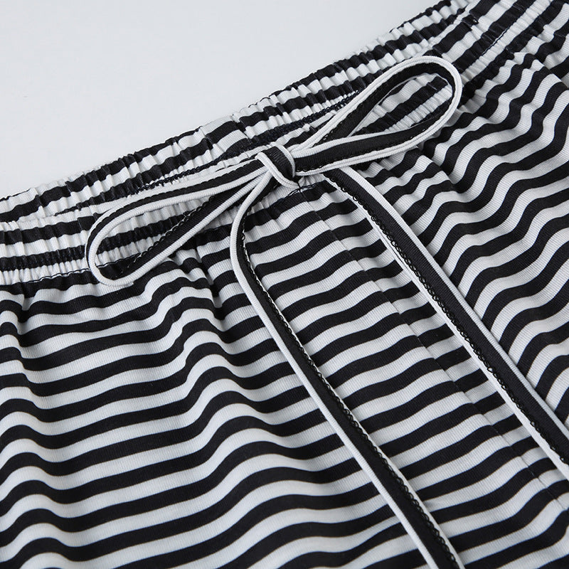 Wide-leg trousers black and white striped waistband close-up