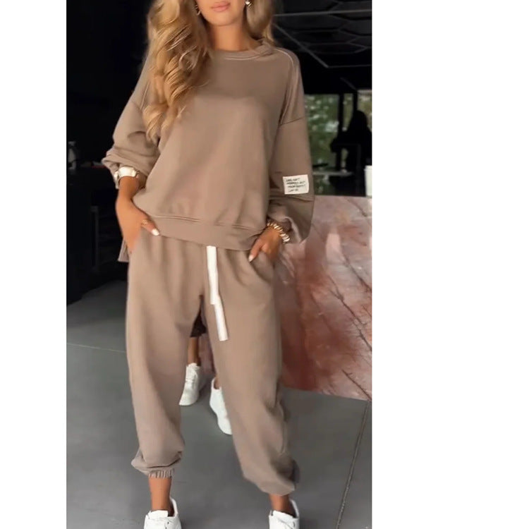 Beige loungewear set with cuffed pants and white sneakers full body view
