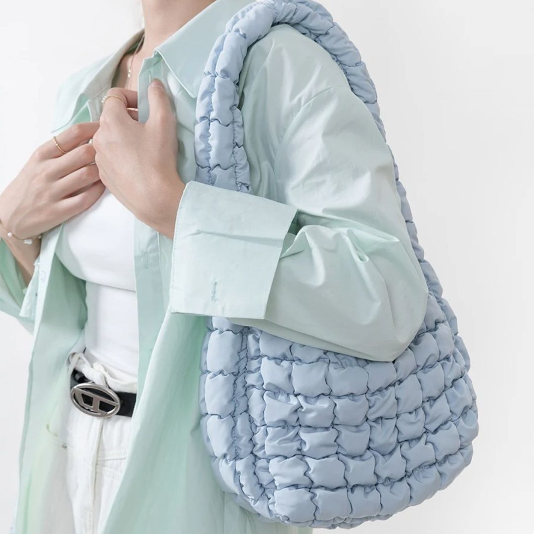 Light blue puffy shoulder bag worn by model