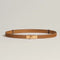 Tan leather belt with gold buckle flat lay