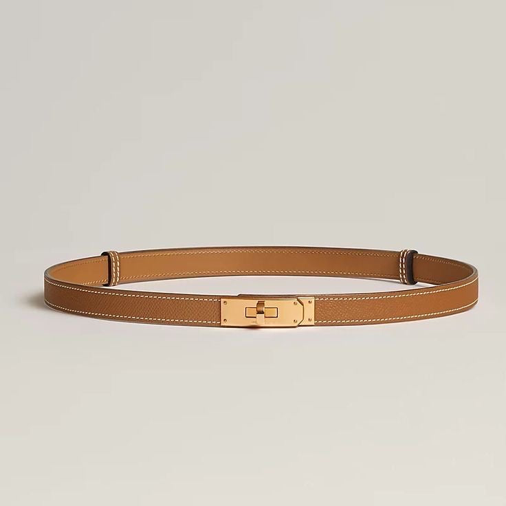 Tan leather belt with gold buckle flat lay
