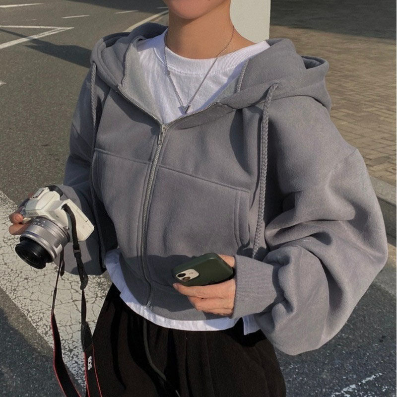 Gray zip-up hoodie with hood worn side view