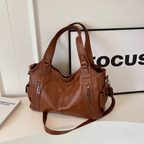 Amber Compacte schoudertas met verstelbare band en stijlvol silhouet