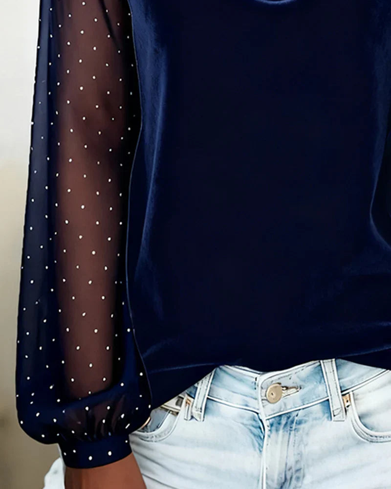 Blue blouse with polka dot sleeves and cowl neck close-up detail