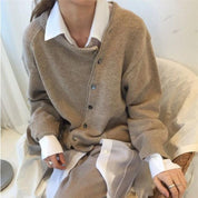 Women's beige knit cardigan with asymmetrical buttons front view