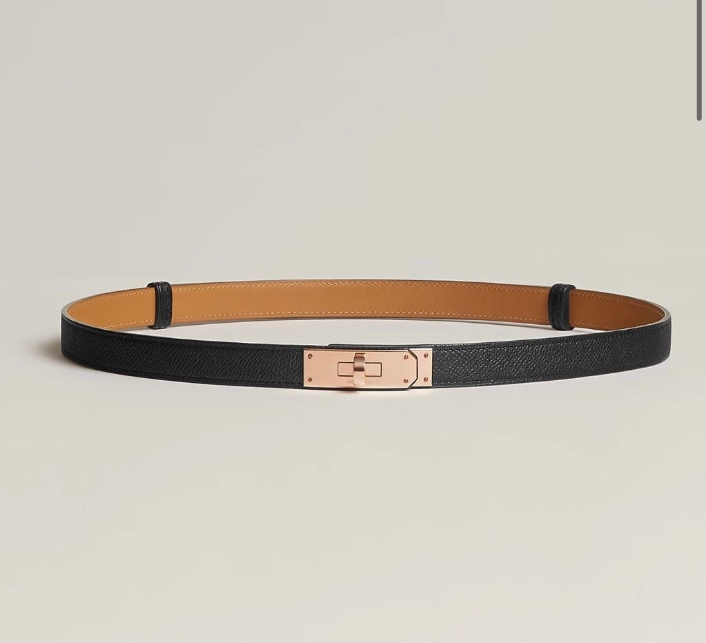 Black leather belt with gold buckle flat lay