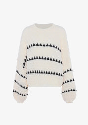 Cream chunky knit sweater with black heart pattern, front view on mannequin