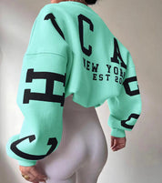 Oversized sweater groen met zwarte letters achterkant