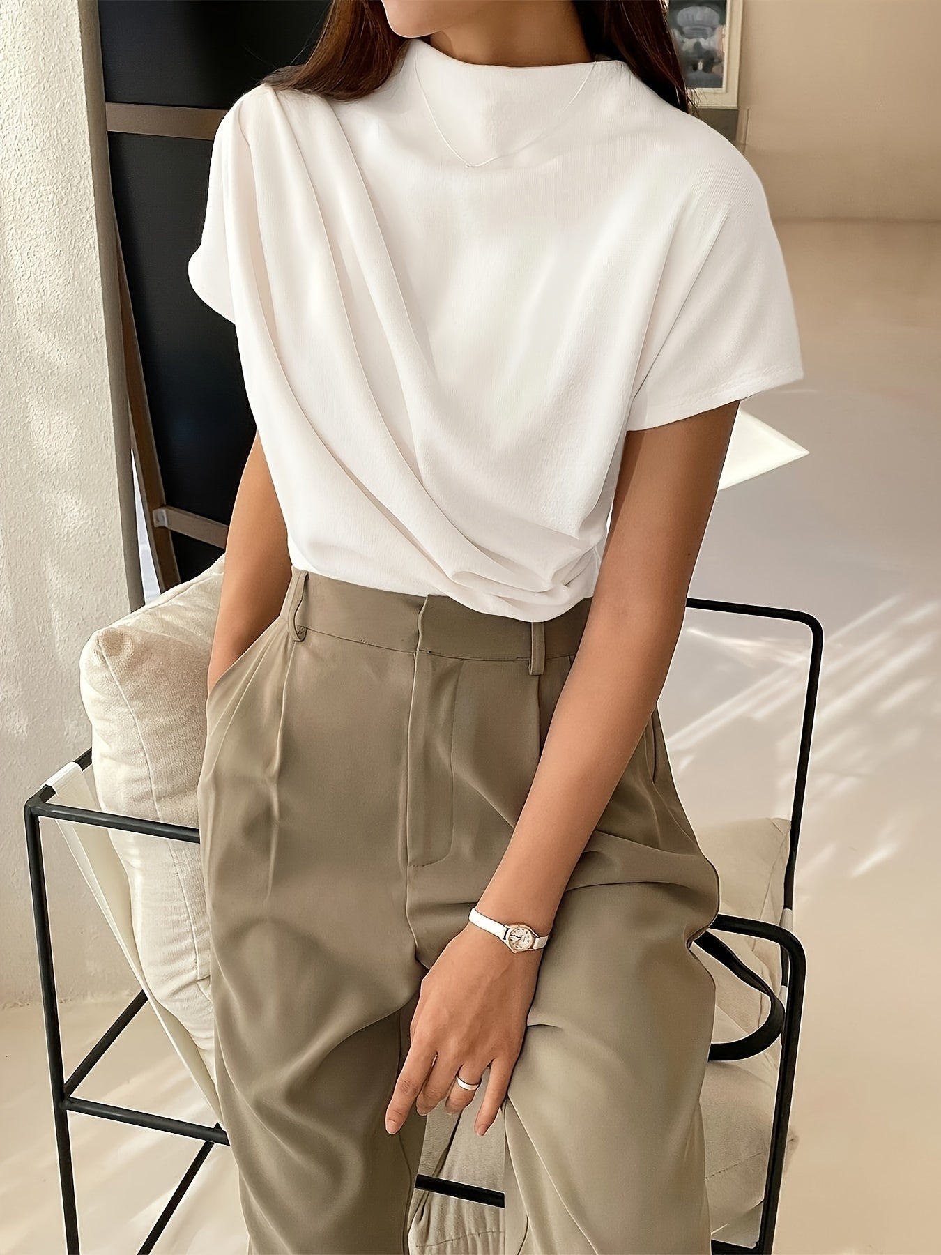 White draped-neck top with loose fit seated view