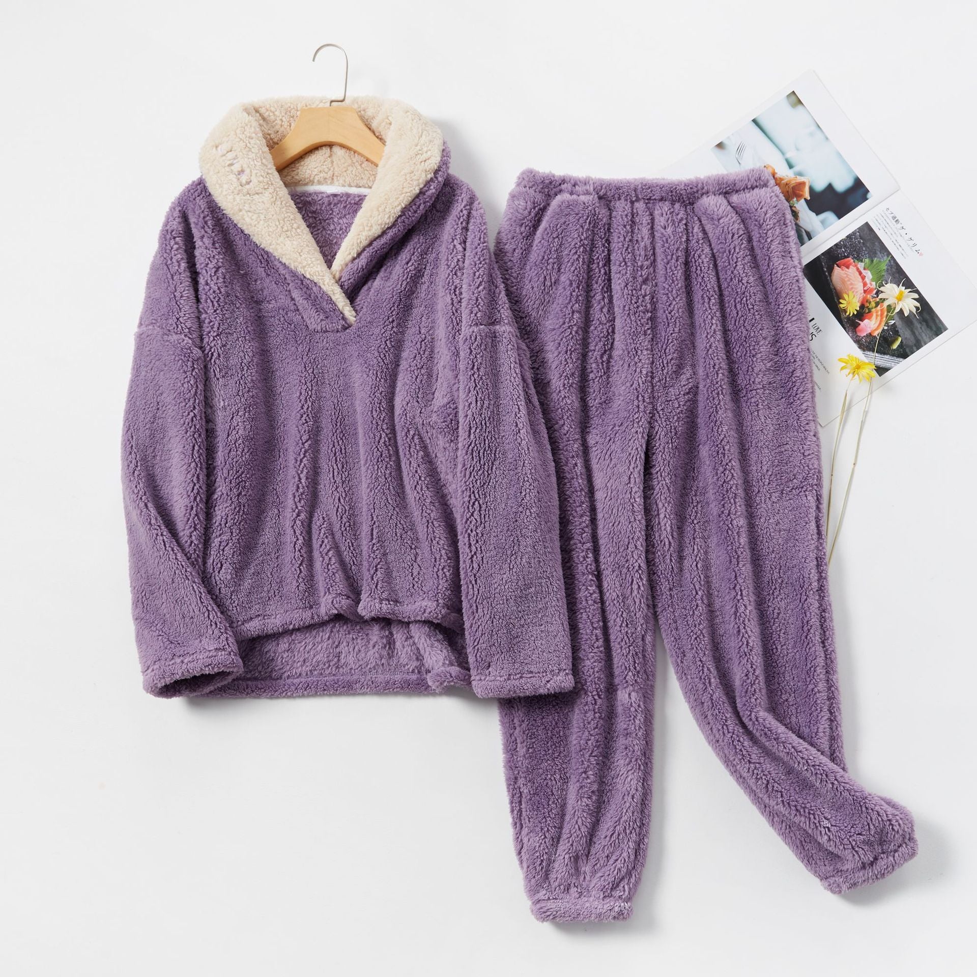 Purple fleece pajama set with cream lining, flat lay