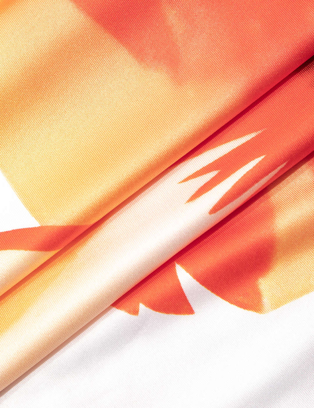 Close-up of orange hibiscus print fabric detail