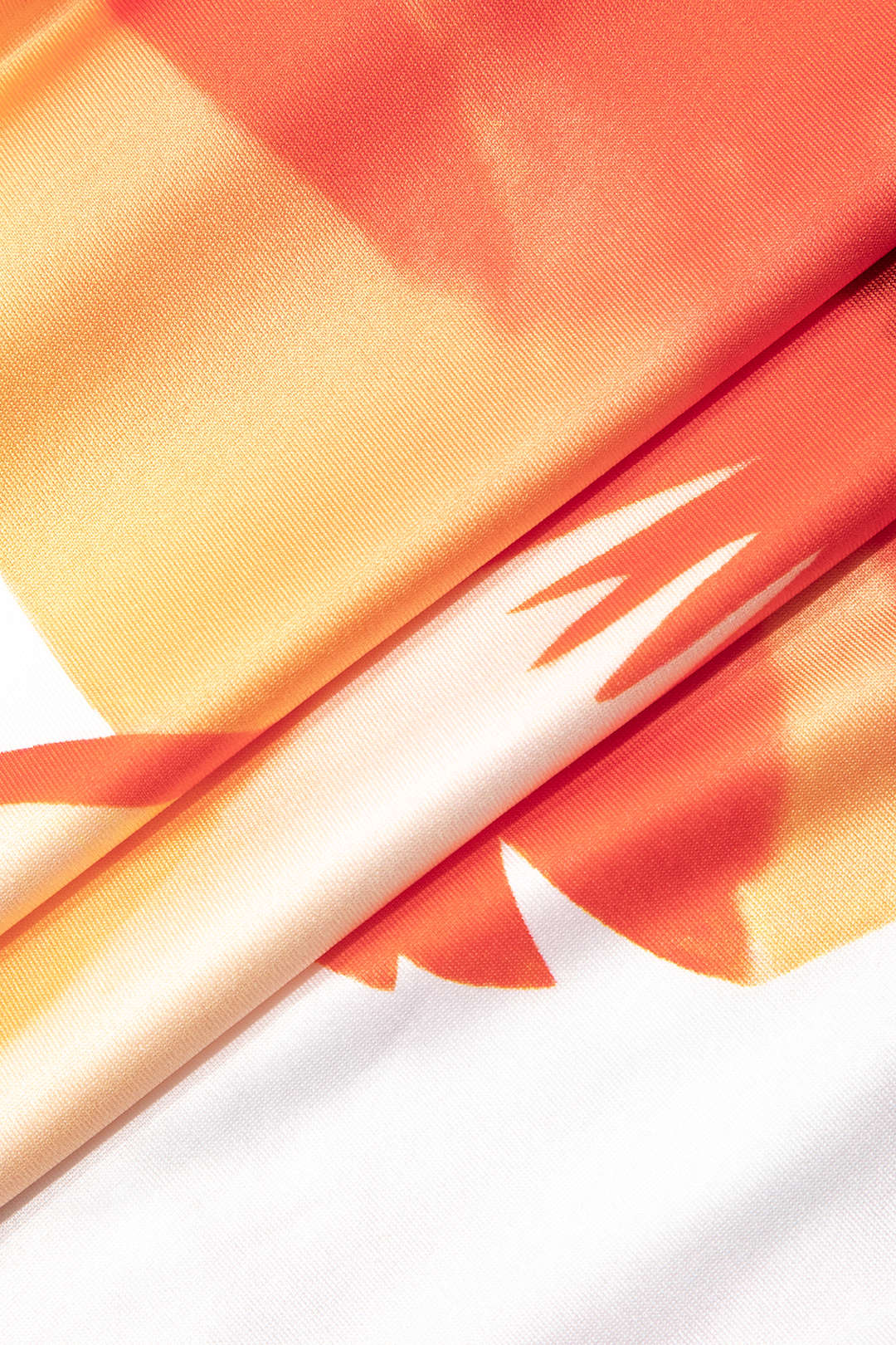 Close-up of orange hibiscus print fabric detail