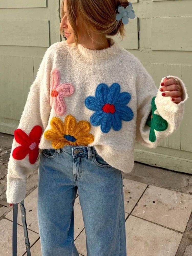 Cream knit sweater with colorful floral appliques front view