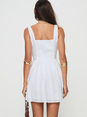 White mini dress with structured bodice and square neckline, back view