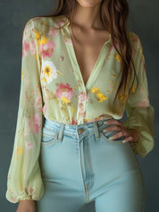 Chiffon blouse with floral print, light green, front view with hands in pockets