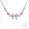 Silver necklace with pink heart stones and bow detail, front view