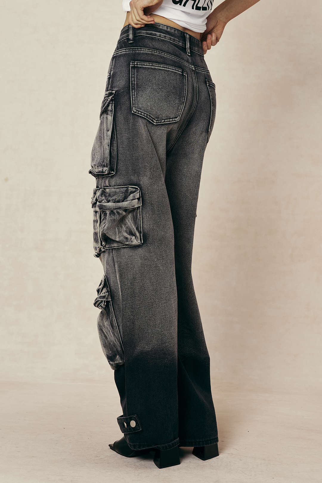Cargo jeans model side view dark wash hands in pockets