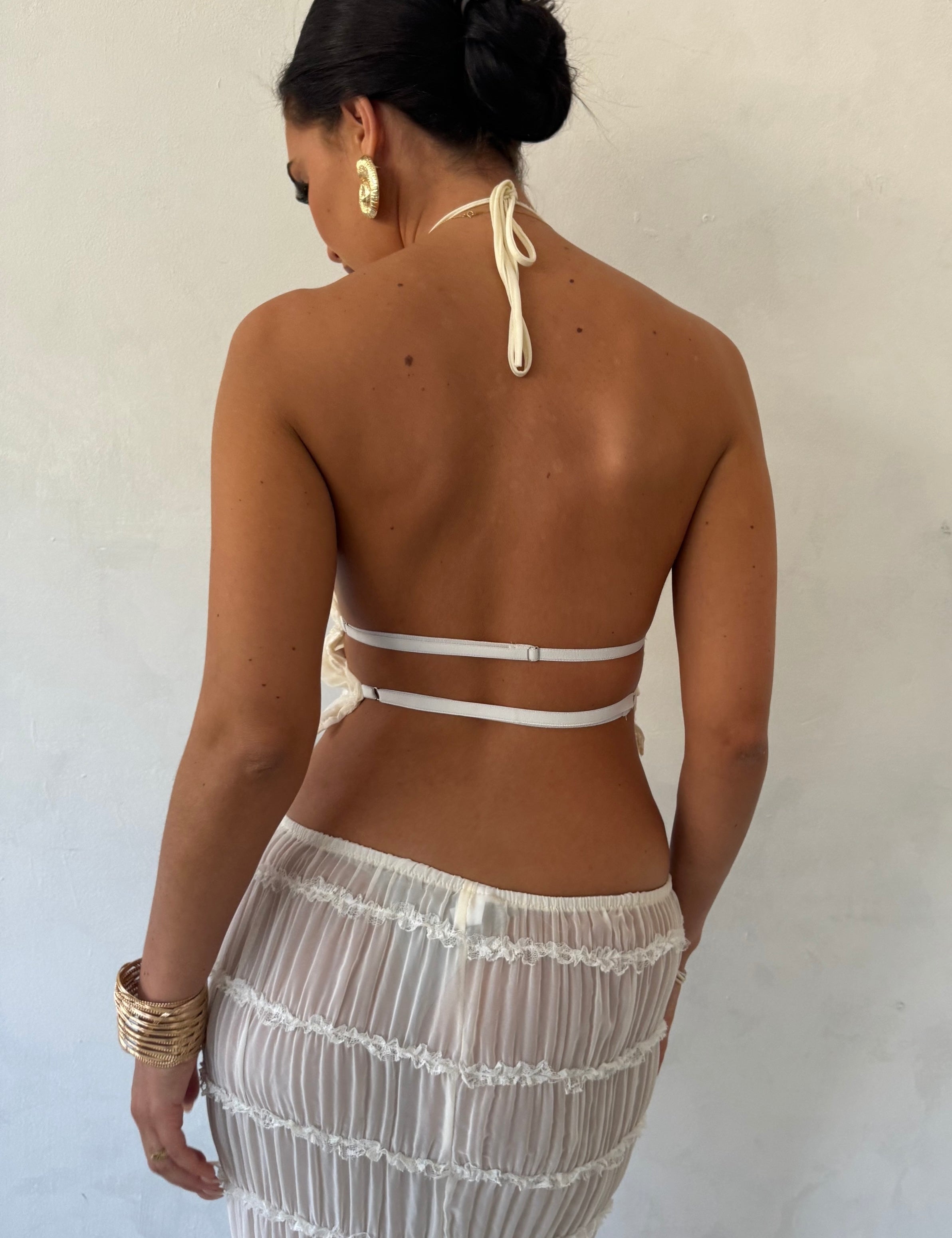 White pleated maxi dress with halter neck, back view