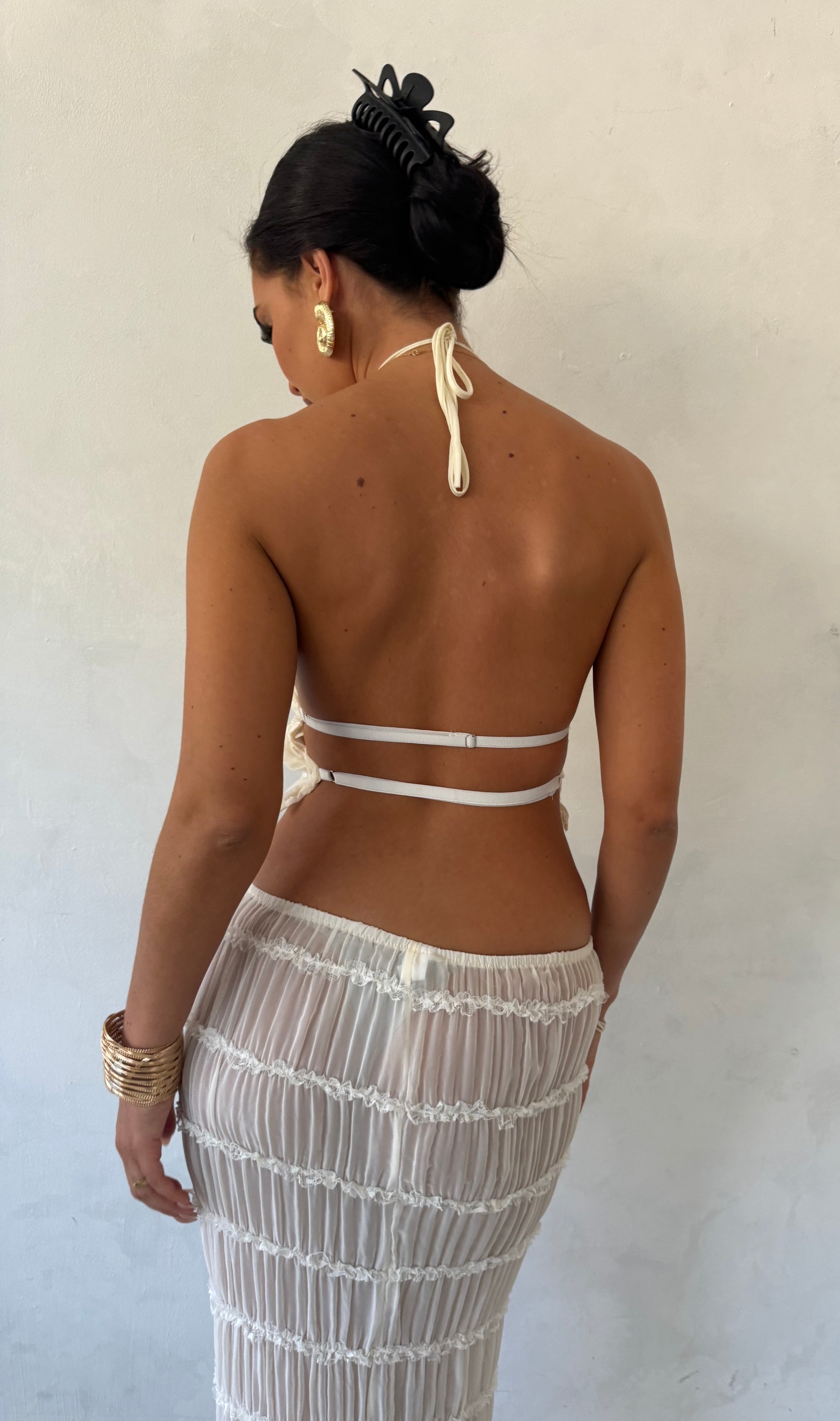 White pleated maxi dress with halter neck, back view