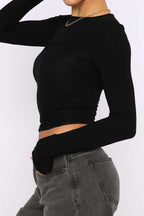 Black long-sleeve crop top front view on model