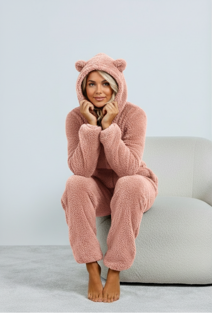 Pink fuzzy onesie with bear ears seated view