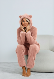 Pink fuzzy onesie with bear ears seated view