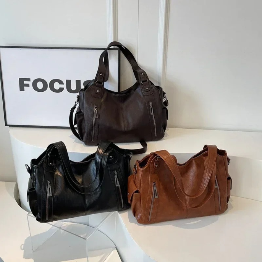 Amber Compacte schoudertas met verstelbare band en stijlvol silhouet