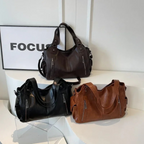 Amber Compacte schoudertas met verstelbare band en stijlvol silhouet