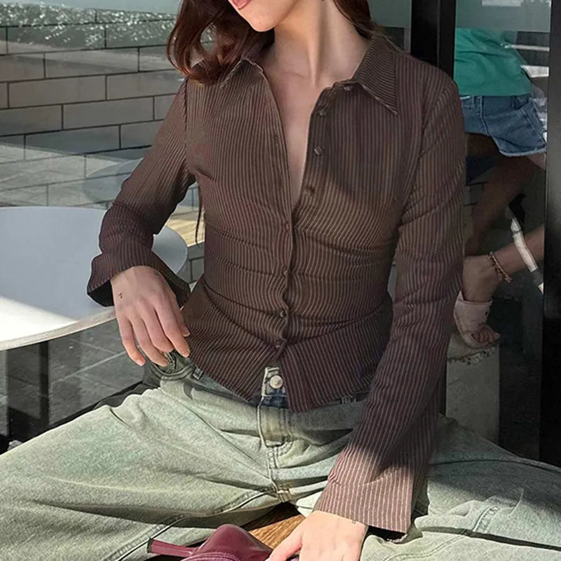 Brown striped shirt with bell sleeves seated view