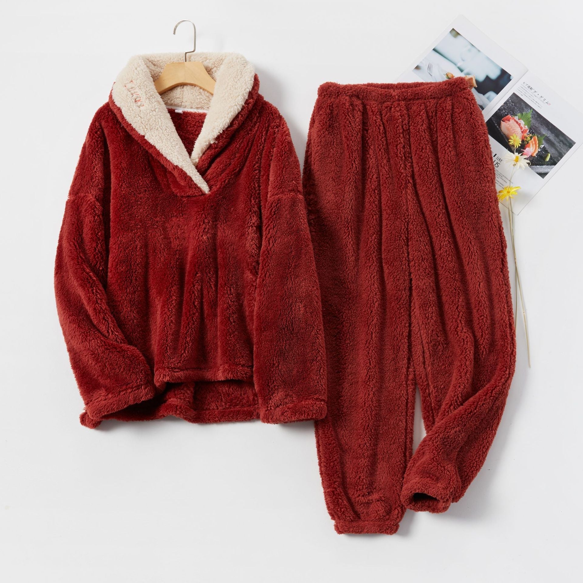 Red fleece pajama set with cream lining, flat lay