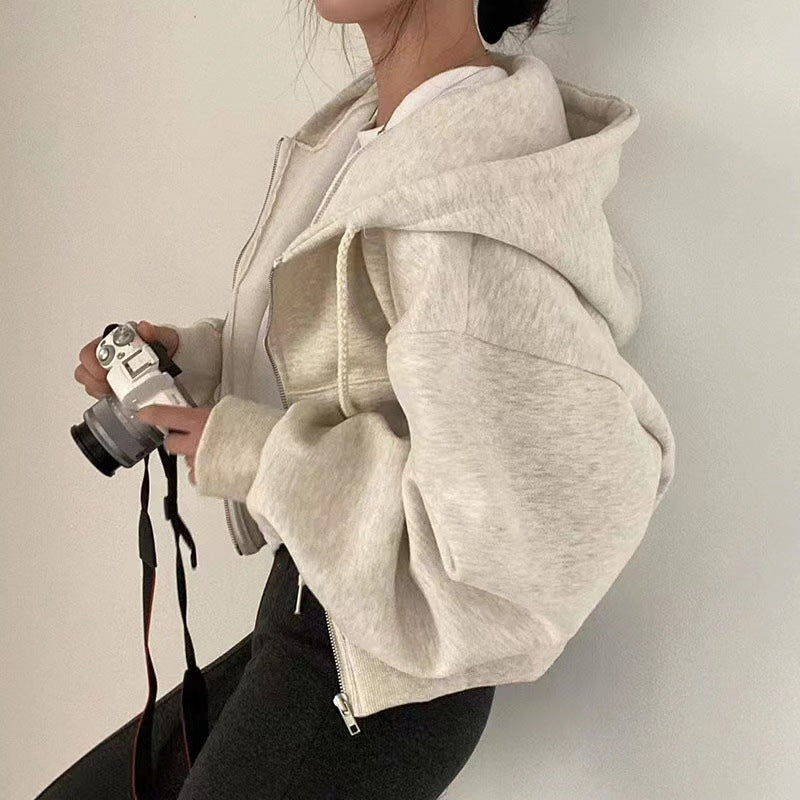 White zip-up hoodie with hood worn side view