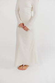 Cream textured maxi dress with bell sleeves close-up detail