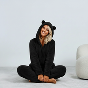 Black fuzzy onesie with bear ears seated view