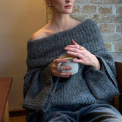 Gray off-shoulder knit sweater with coffee cup